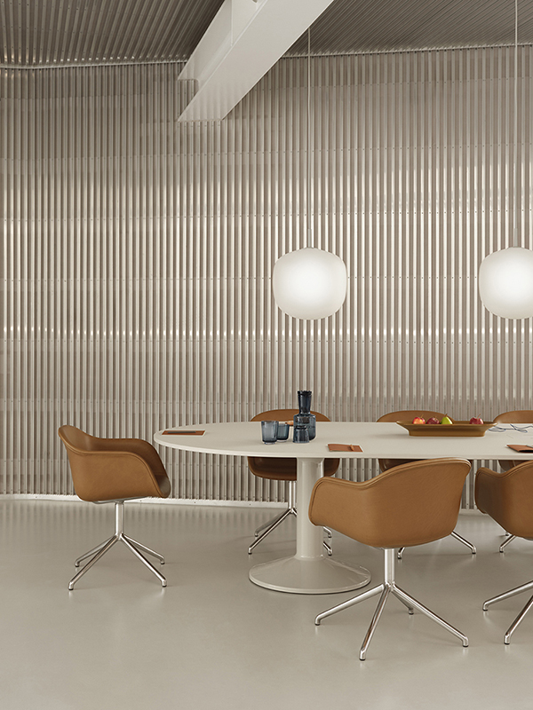 Refined cognac leather Fiber Armchair on a chrome swivel base, paired with a grey Midst conference table with power and Rime pendant lamps. Ideal for professional or meeting spaces.