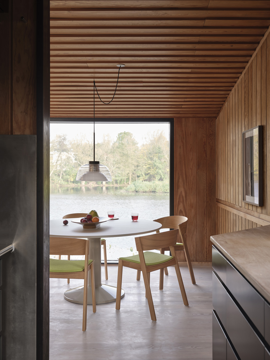 The Cover Side Chair in Acca 961 oak finish, styled with a two-layer black and brown-green Mere Bowl placed on a Midst table. Adds a refined touch to dining or office spaces.