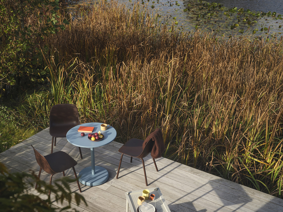 Three Fiber Outdoor Side Chairs standing outside on a terrace in the sun styled with a pale blue Linear Steel Café Table. 