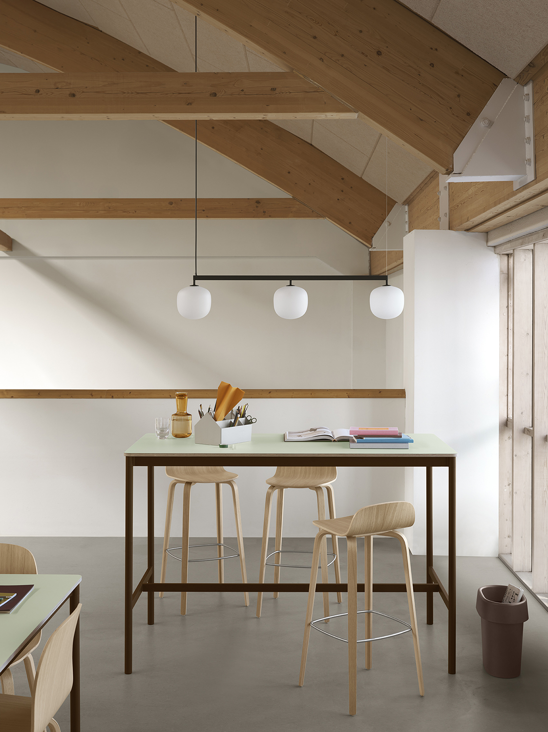 Base High Table in a minimalist setting with wooden high chairs and a rail pendant lamp, showcasing a sleek Nordic style.