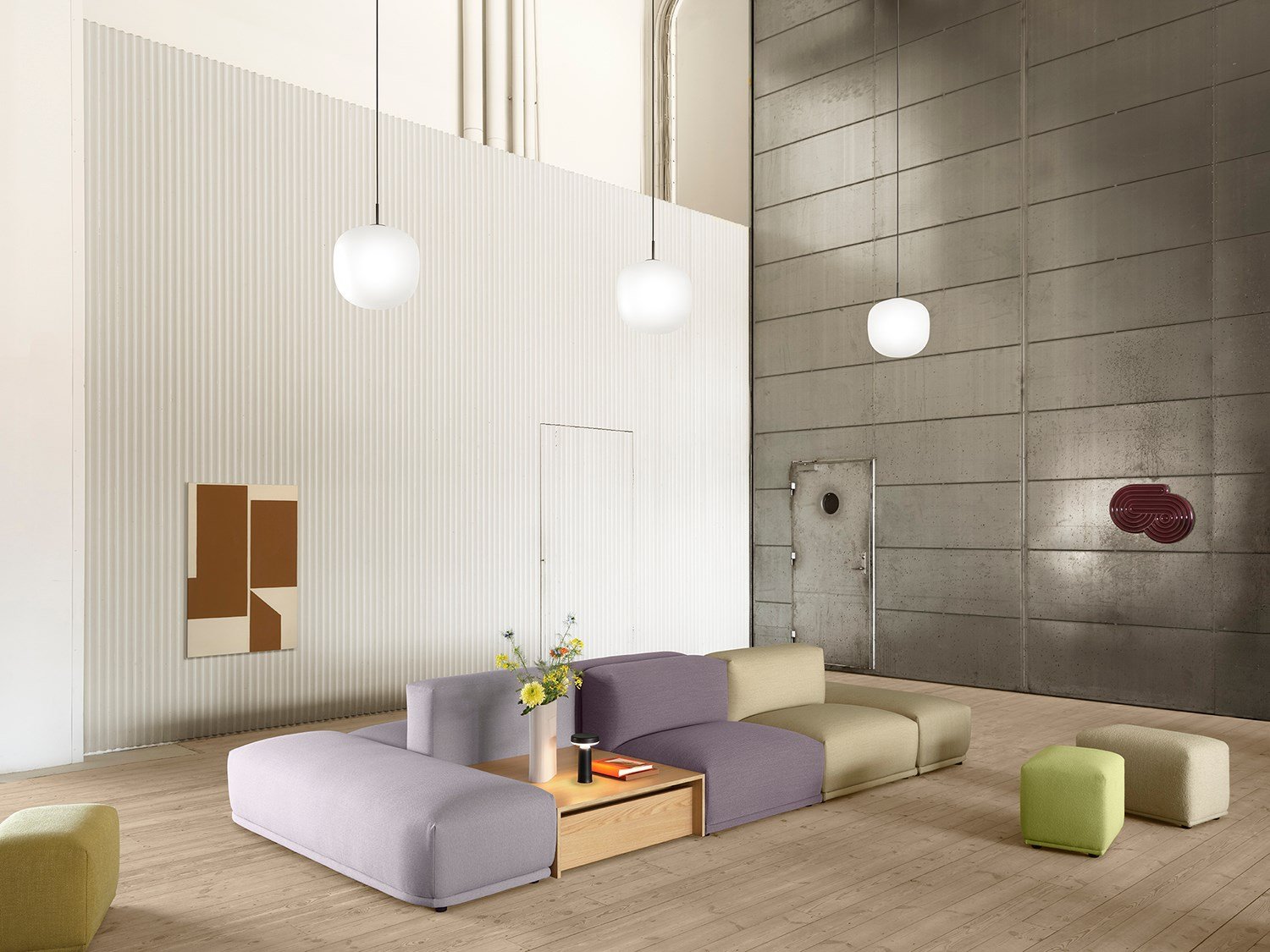 Connect Sofa in a spacious, minimalistic room with white and grey walls, accented by three glass pendant lights hanging above. Connect Sofa in a spacious, minimalistic room with white and grey walls, accented by three glass pendant lights hanging above.