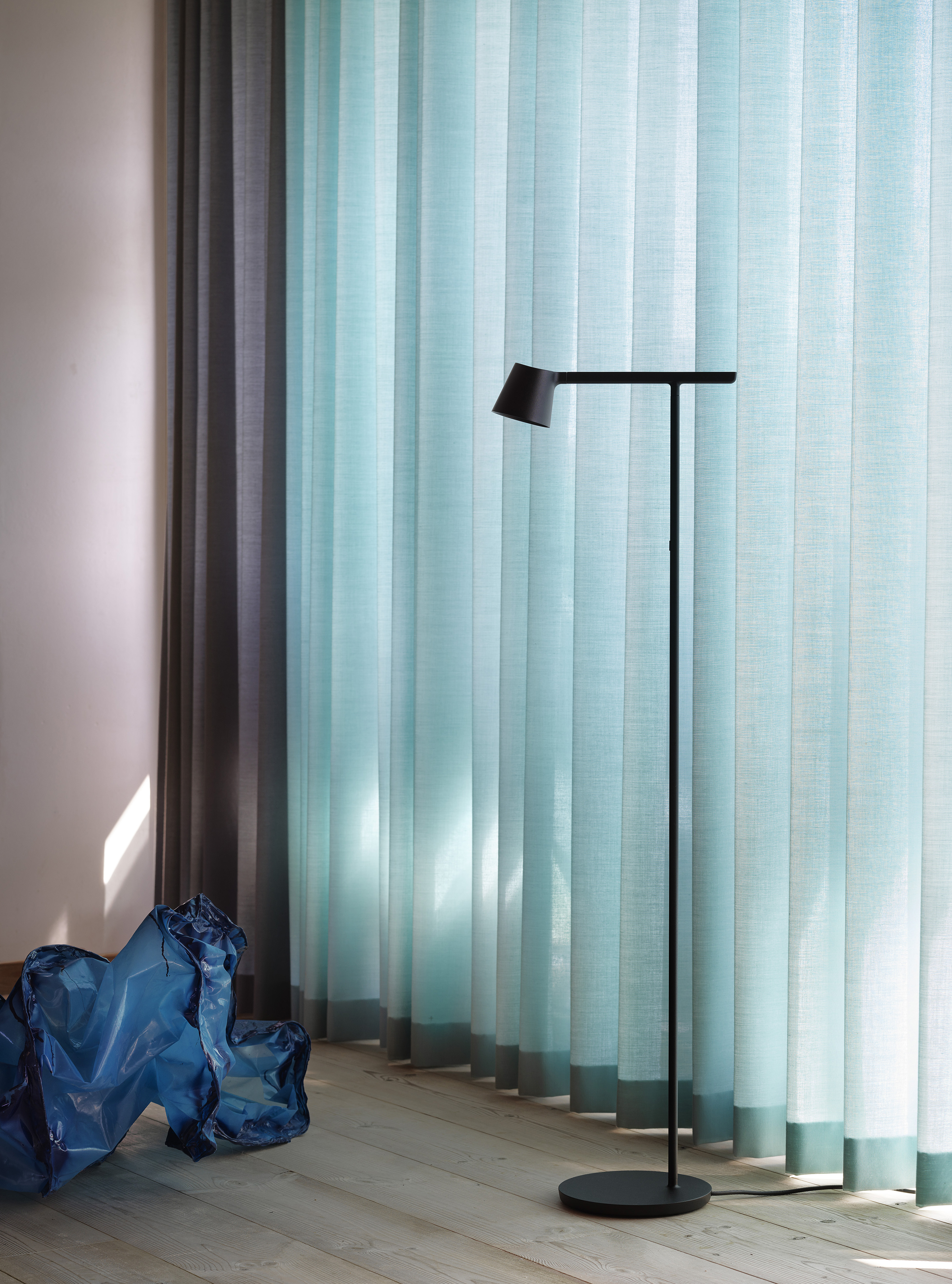 Tip Floor Lamp in black, shown in a modern setting highlighting its functional design.