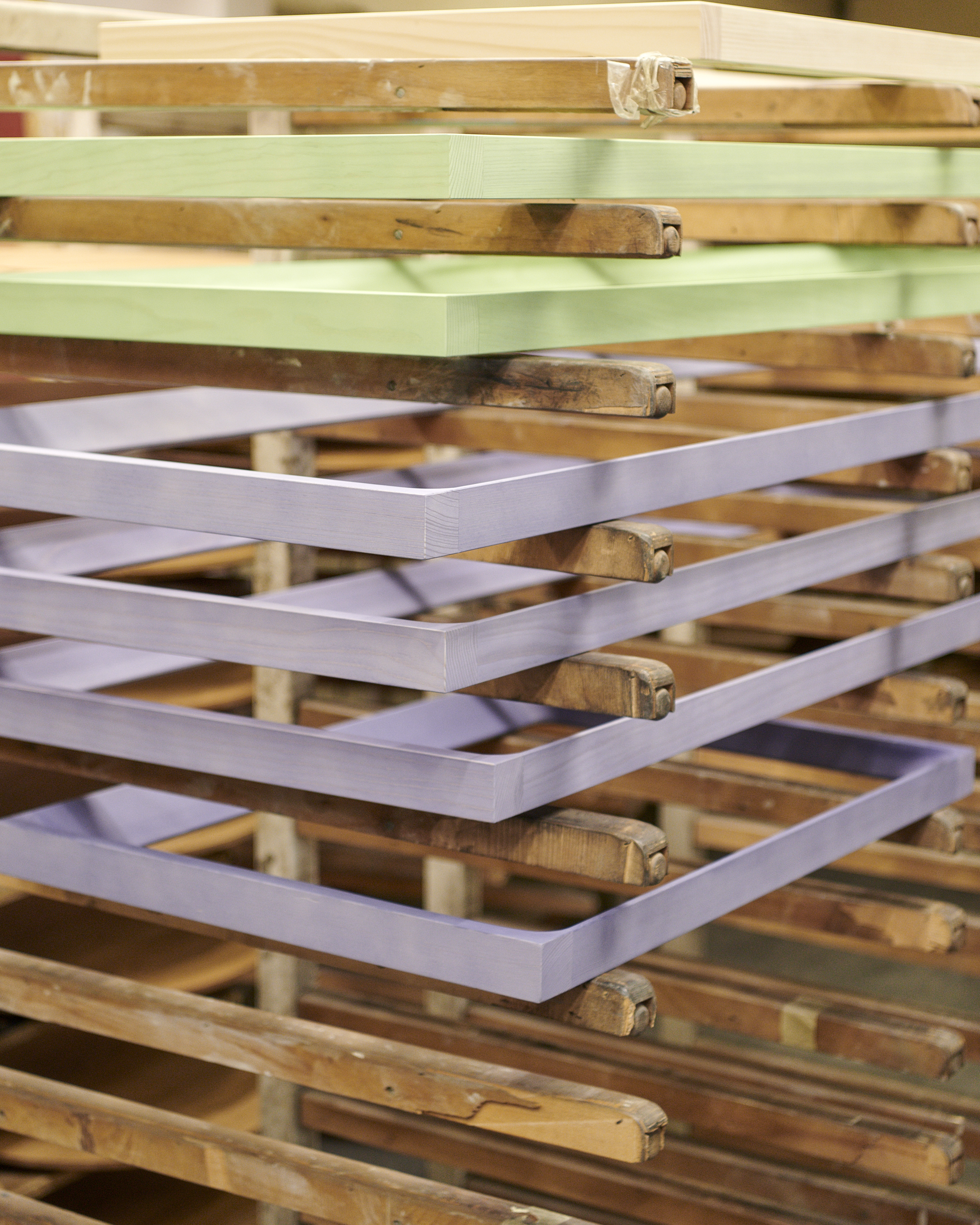 Close-up factory image showing Muuto Arced Mirror, emphasizing craftsmanship and material quality in the production process.