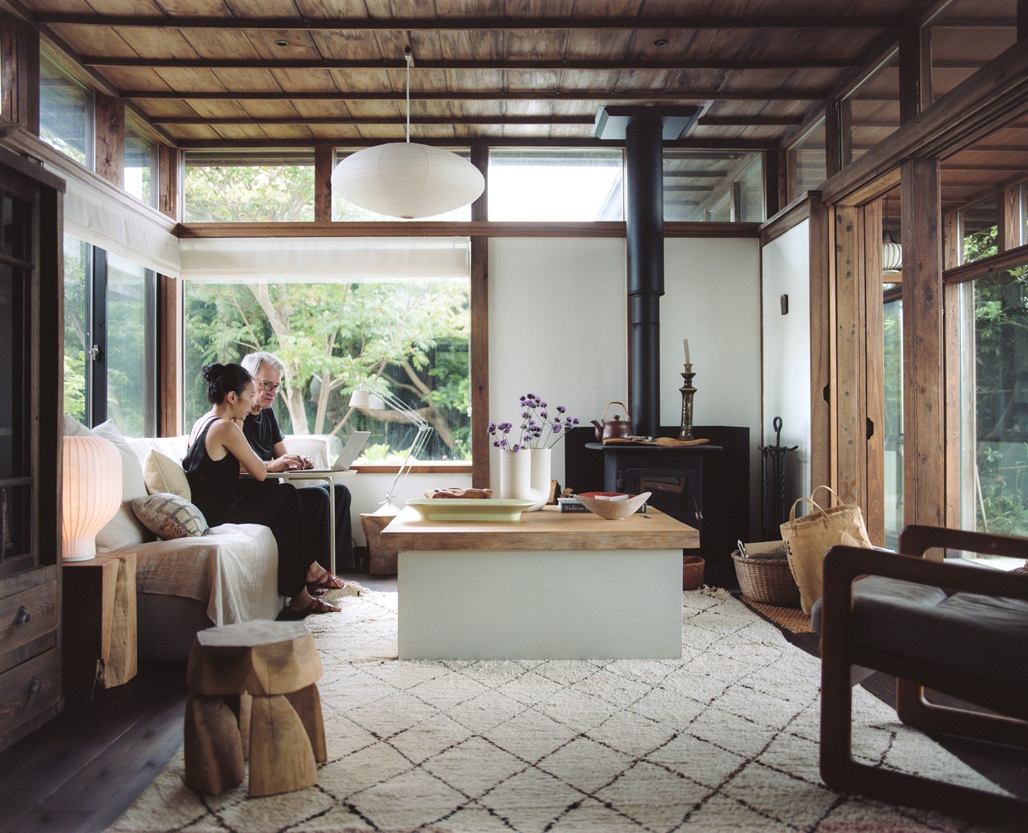 Giselle and Philippe sitting in a wooden Japanese style living room, using a laptop.
 Giselle and Philippe sitting in a wooden Japanese style living room, using a laptop.
