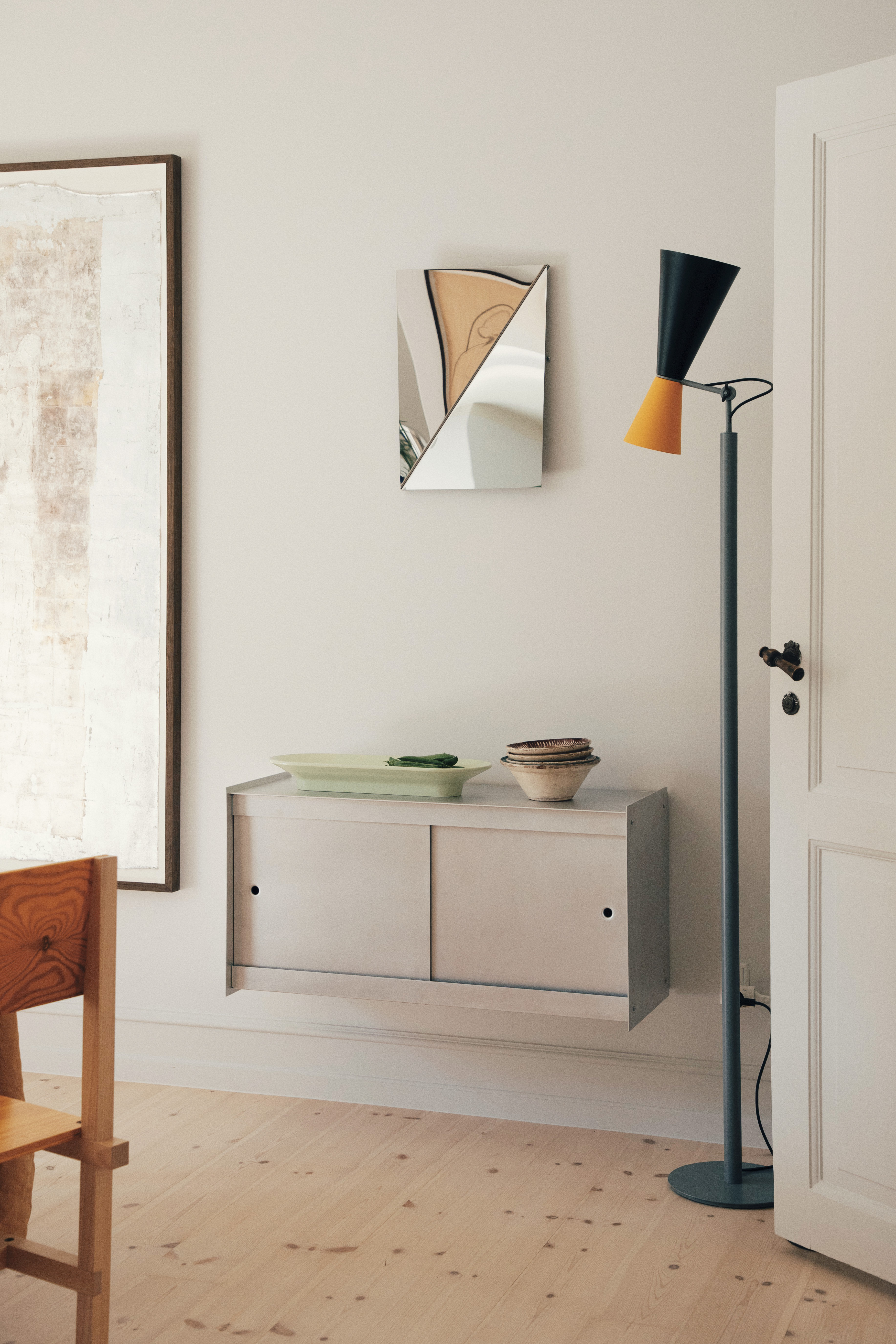 Gaze Mirror by Muuto placed above a sideboard in Michael Schneider’s home, reflecting a warm and understated interior with natural materials and clean lines.