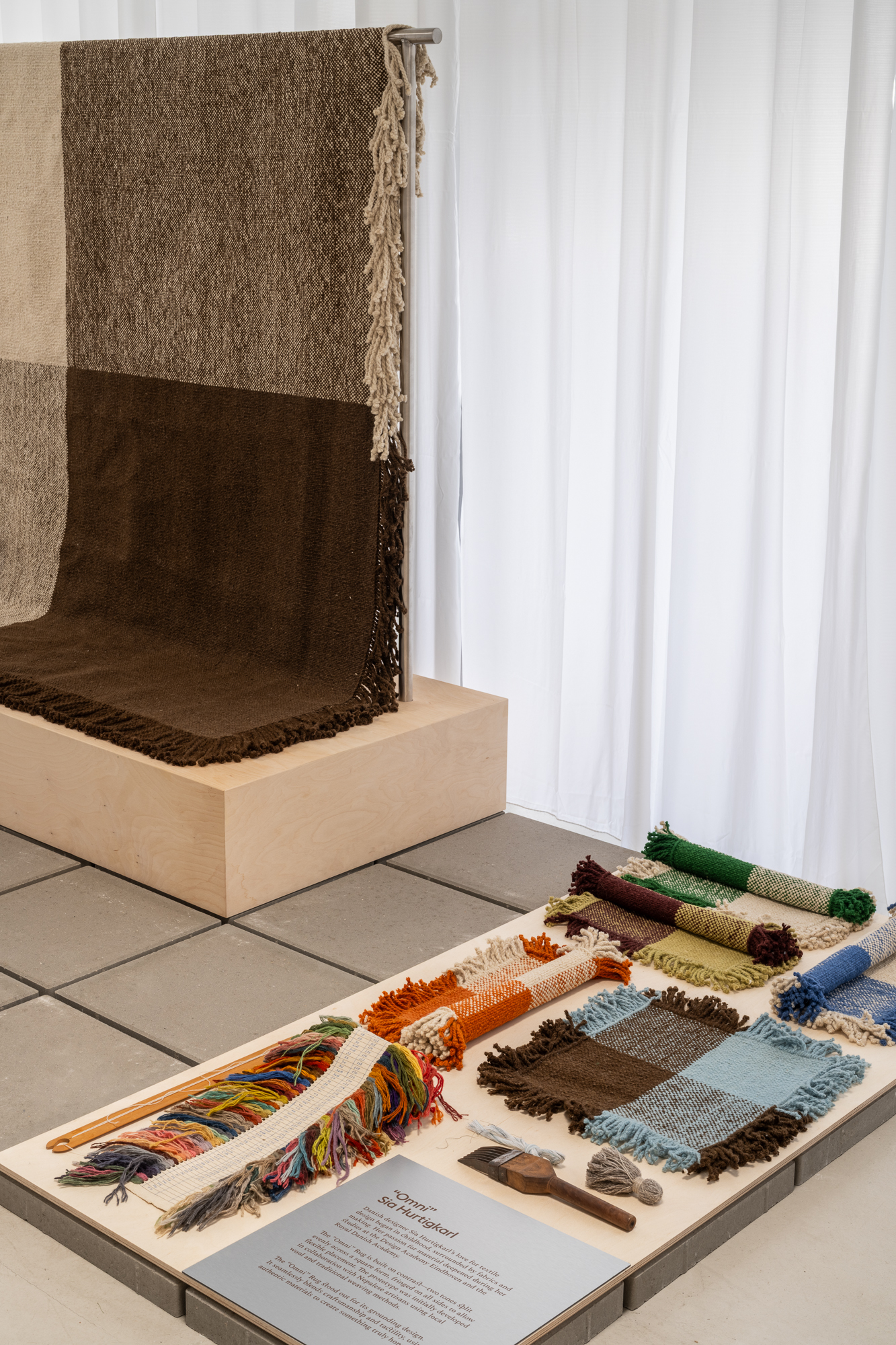 The Omni Rug is displayed in a styled setting designed to invite people to explore and learn more about its design.