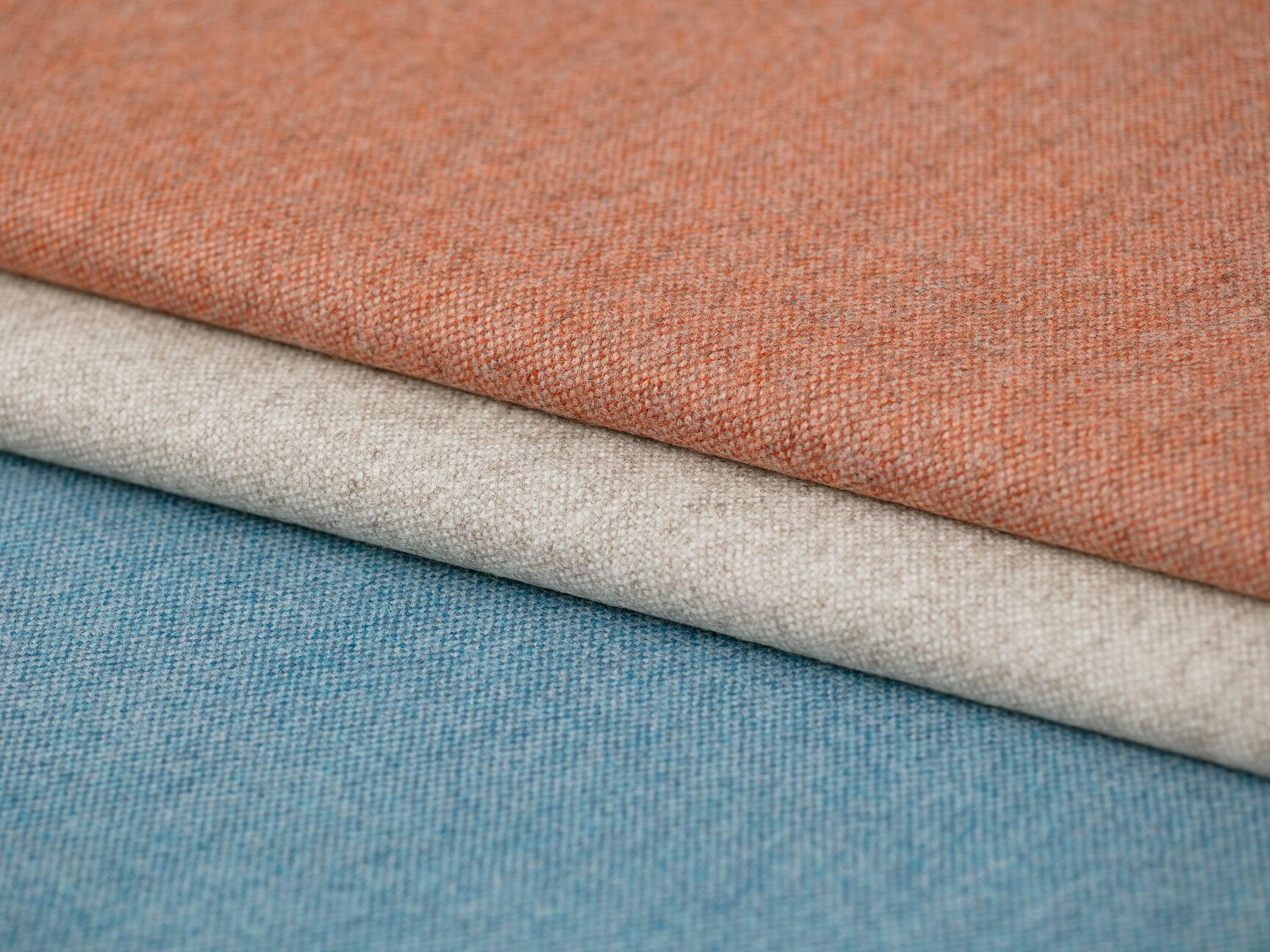 Colorful fabrics displaying a spectrum of colors with detailed textures.