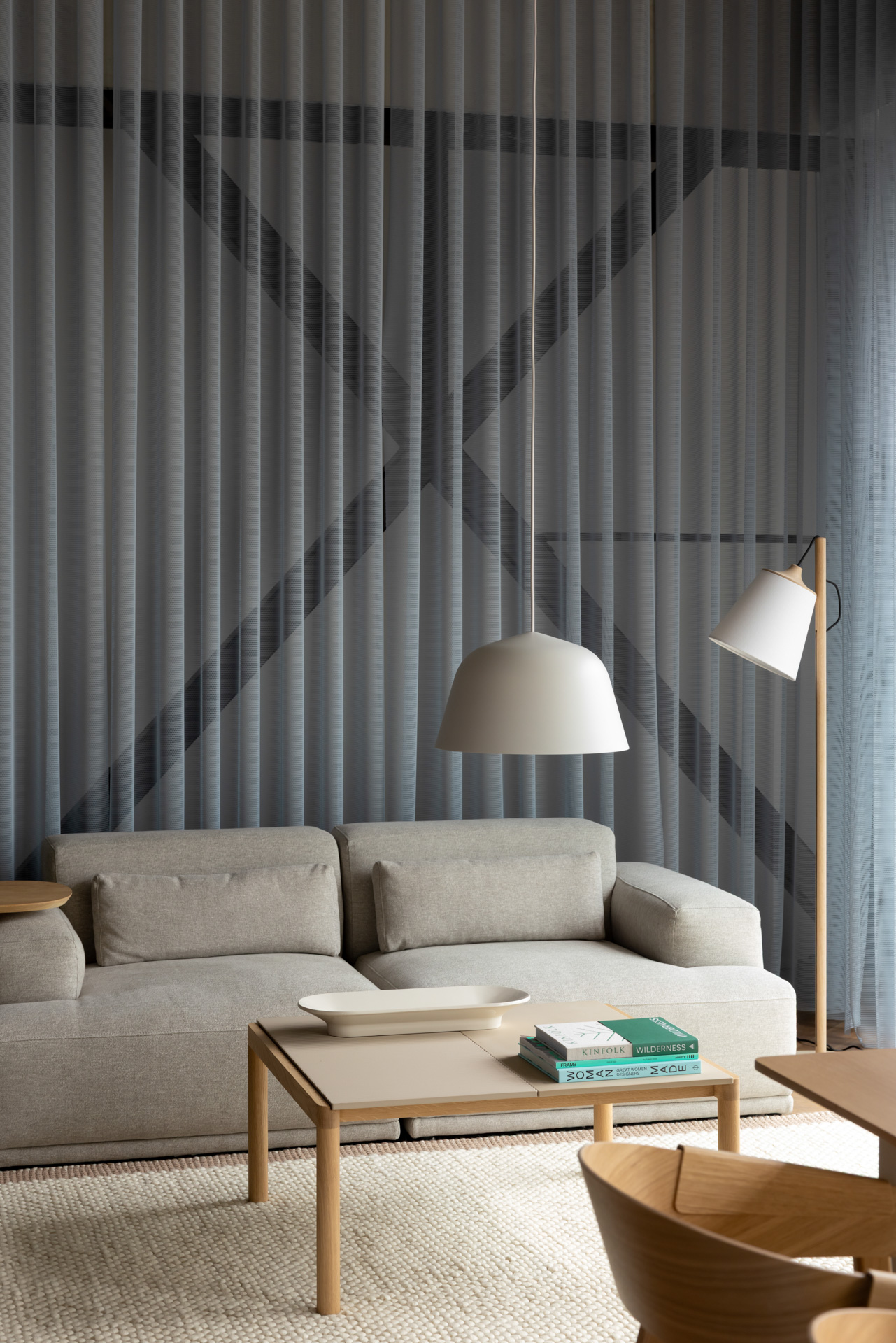 Image of a Sand Connect Sofa paired with a wooden coffee table, set on a light beige rug in the Auckland Flagship Store.