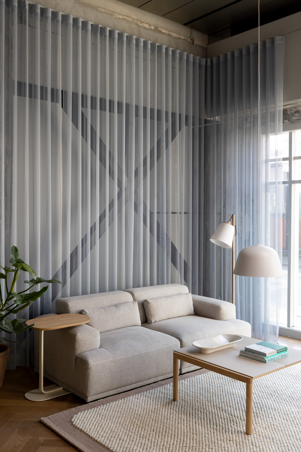 Image of a Sand Connect Sofa paired with a wooden coffee table, set on a light beige rug in the Auckland Flagship Store.