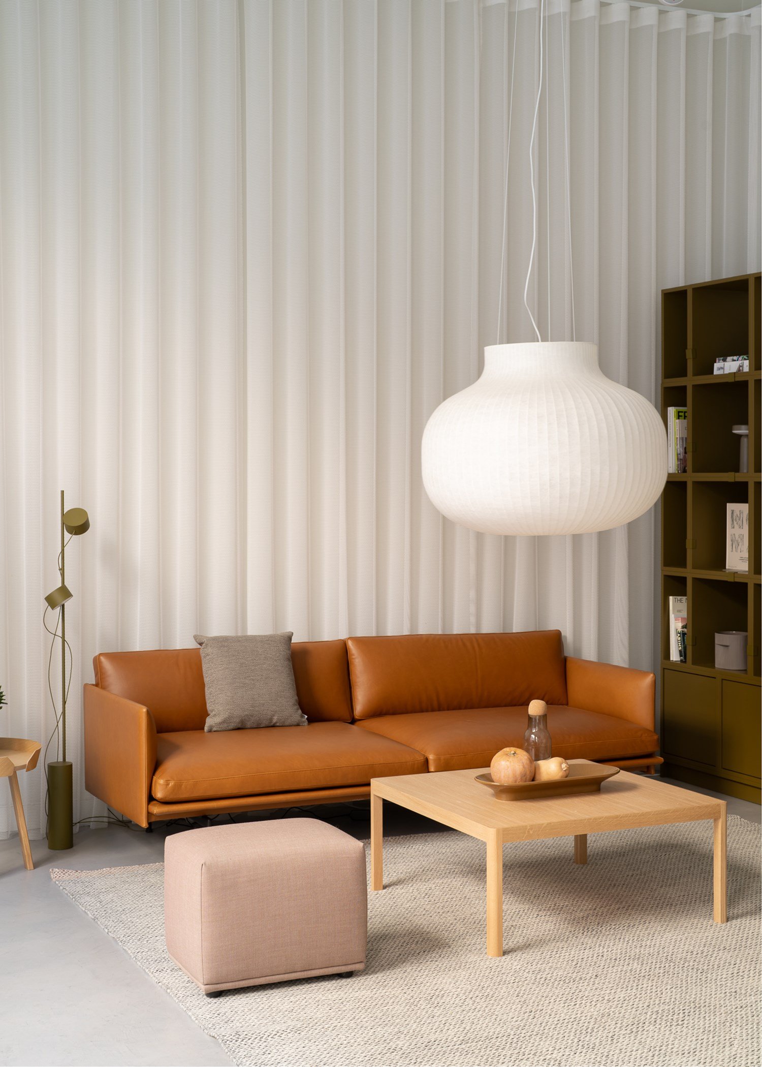 A lounge area with a leather sofa placed on a rug together with a sofa table and a pouf.  Creating a nice cozy atmosphere.  A lounge area with a leather sofa placed on a rug together with a sofa table and a pouf.  Creating a nice cozy atmosphere.