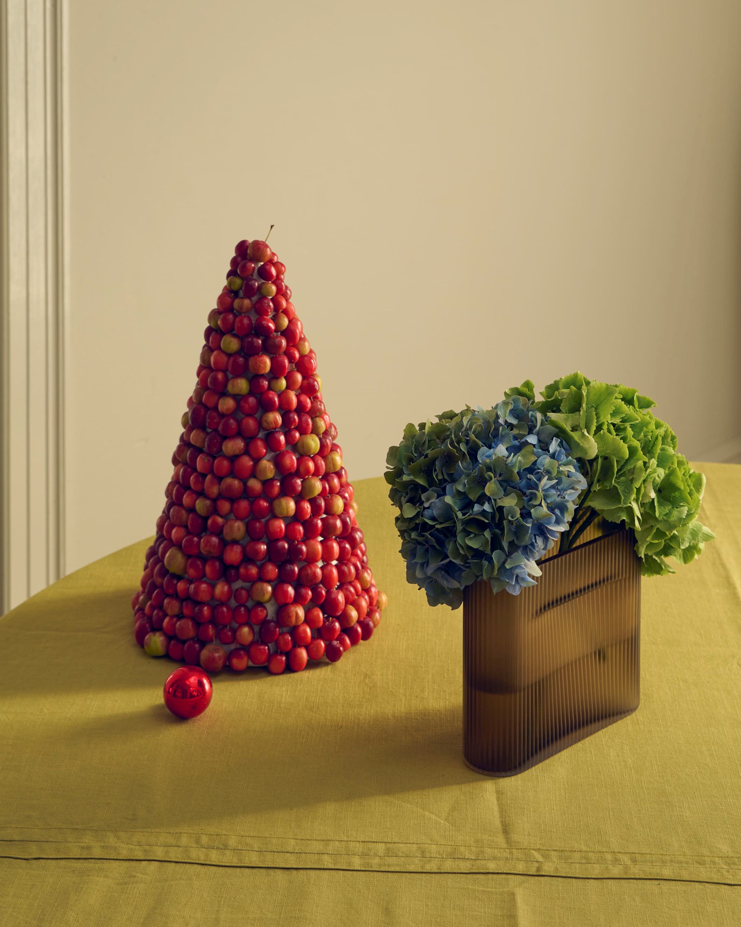 The Ridge Vase frosted glass in taupe, styled in a calm holiday setting with soft natural light and seasonal elements. The Ridge Vase frosted glass in taupe, styled in a calm holiday setting with soft natural light and seasonal elements.