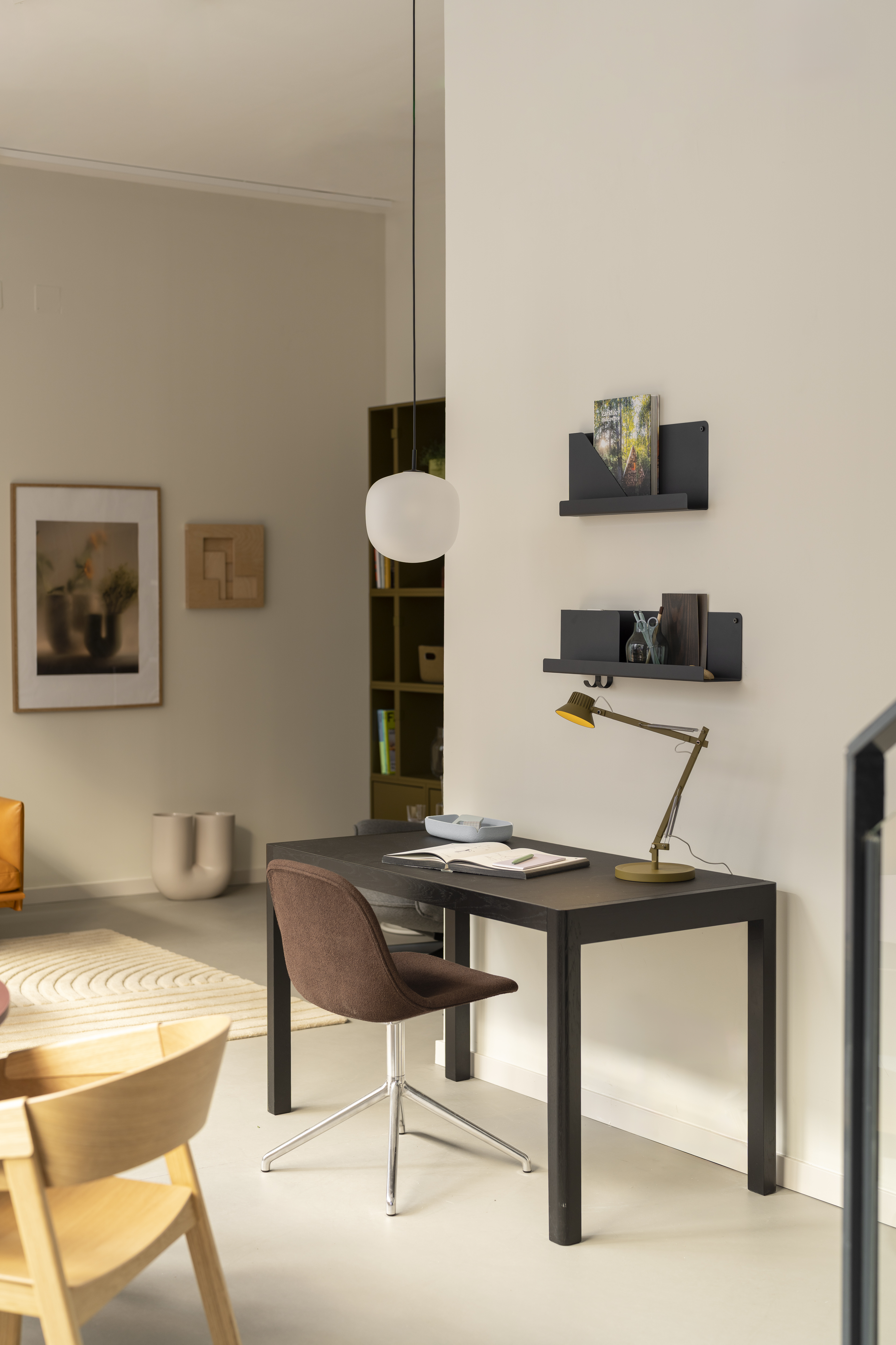 The Workshop Table by Muuto shown in the Madrid showroom, paired with modern furnishings in a warm, minimal space focused on craftsmanship and simplicity.